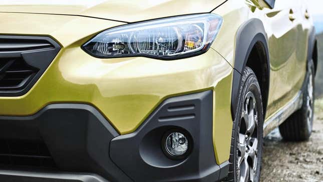 A close-up of the front of a subaru crosstrek in piss yellow