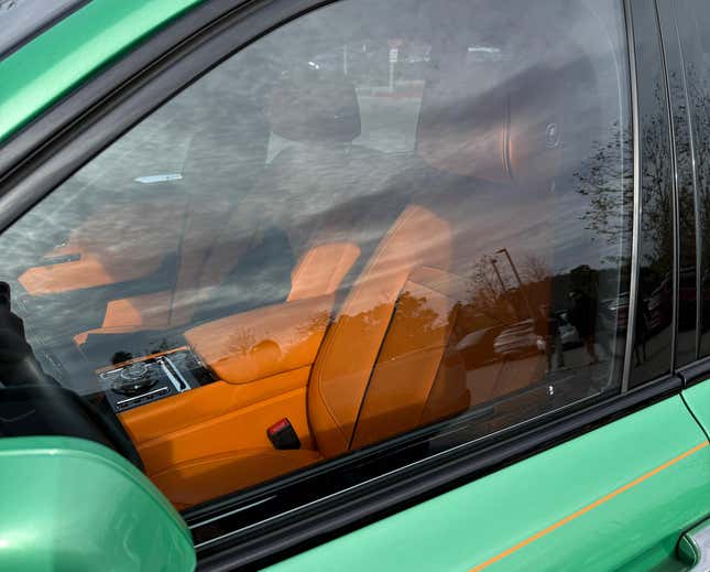 Orange interior of a green Rolls-Royce Cullinan Black Badge