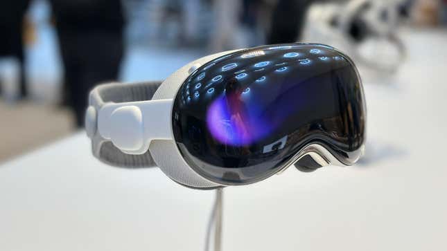 An Apple Vision Pro headset on a stand with a purple eyesight.