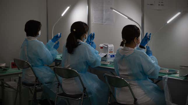 Medical staff prepare syringes of the Moderna vaccine at a vaccination center on June 30, 2021 in Tokyo, Japan.