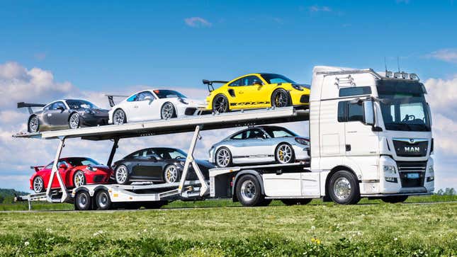 "Toys For Boys" Collection of Porsche 911s on transporter