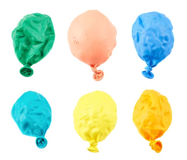 Six balloons of different colors are laid out, all somewhat deflated.