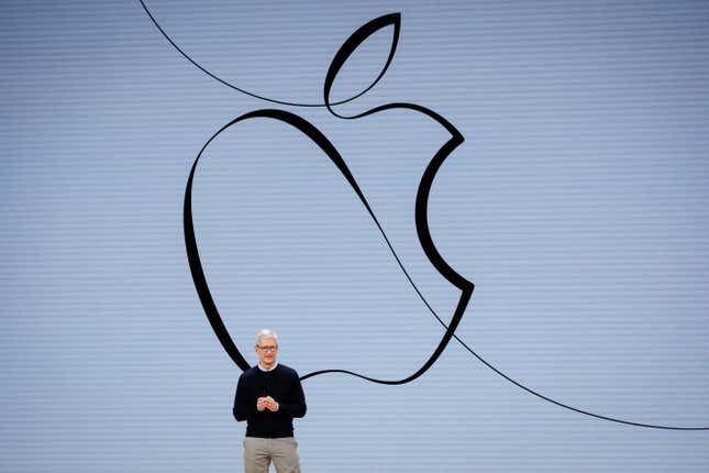 tim cook in front of a display showing the apple logo