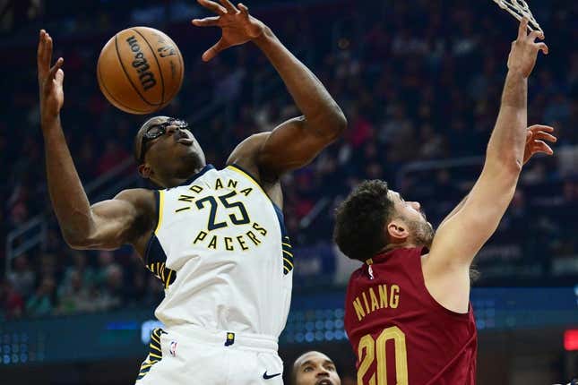 Oct 28, 2023; Cleveland, Ohio, USA; Indiana Pacers forward Jalen Smith (25) goes for a rebound against Cleveland Cavaliers forward Georges Niang (20) during the first half at Rocket Mortgage FieldHouse.