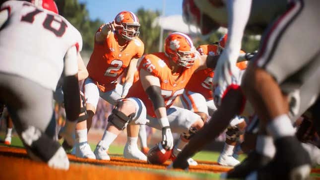 A screenshot of EA Sports College Football 25 showing a quarterback calling a play on the line of scrimmage. A few defensive players can be seen in the foreground. 