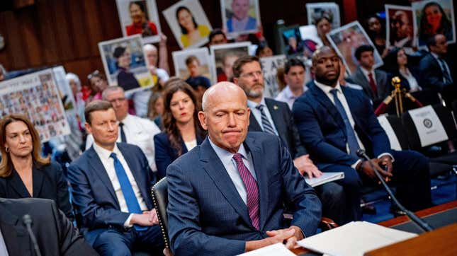 Family members of those killed in the Ethiopian Airlines Flight 302 and Lion Air Flight 610 crashes hold photographs of their loved ones as Boeing CEO Dave Calhoun arrives for a Senate Homeland Security and Governmental Affairs Investigations Subcommittee hearing on Boeing's broken safety culture on Capitol Hill on June 18, 2024 in Washington, DC.