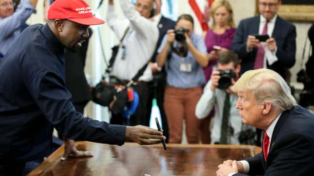 Kanye West , left, shows a picture of a plane to President Donald Trump during a meeting in the Oval office of the White House on October 11, 2018 in Washington, DC. 