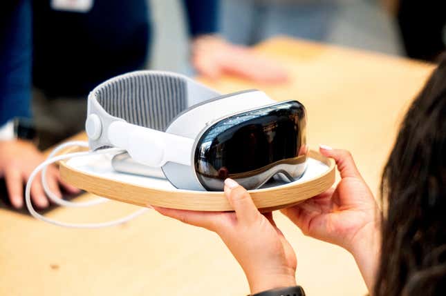 An Apple worker holds a Vision Pro headset during the first day of sales at a Palo Alto, Calif., Apple store on Friday, Feb. 2, 2024. (AP Photo/Noah Berger)