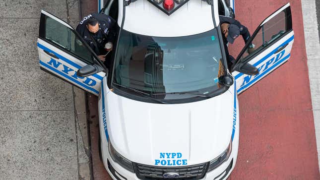 Overhead shop of two police officers exiting a NYPD Ford Explorer on the street. 