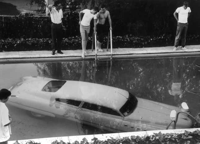 4th May 1961: A submerged car which its drunken owner 'parked' in a swimming pool in Beverly Hills, California, believing it to be a parking space. Nobody was injured in the process