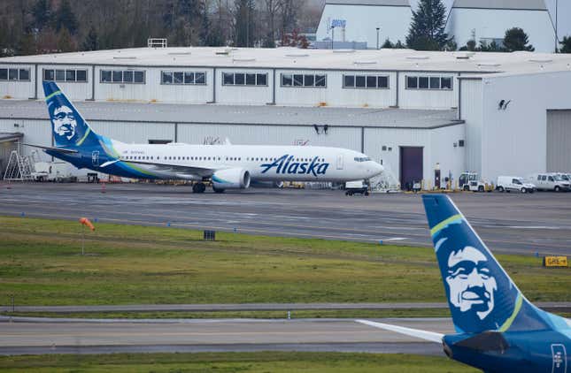 Alaska Airlines N704AL, a 737 Max 9 which made an emergency landing at Portland International Airport after a part of the fuselage broke off mid-flight on Friday, is parked at a maintenance hanger in Portland, Ore., Saturday, Jan. 6, 2024. (AP Photo/Craig Mitchelldyer)