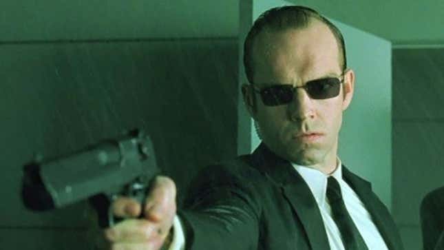 Agent Smith pointing a gun