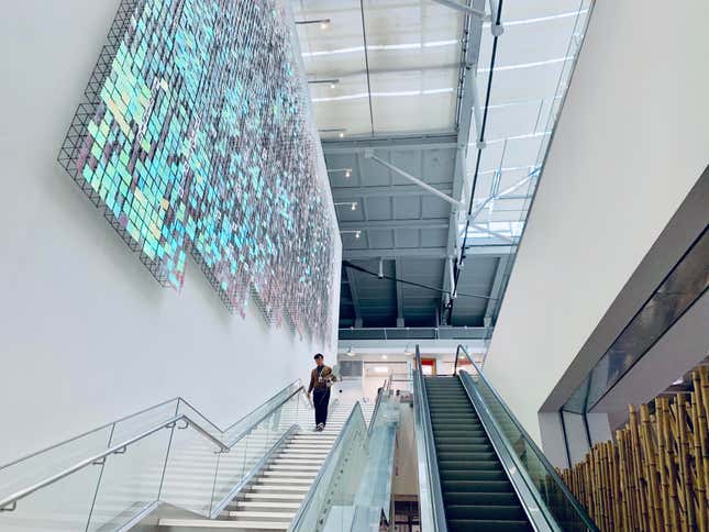 wide view looking up stairs and an escalator in ByteDance's Beijing office