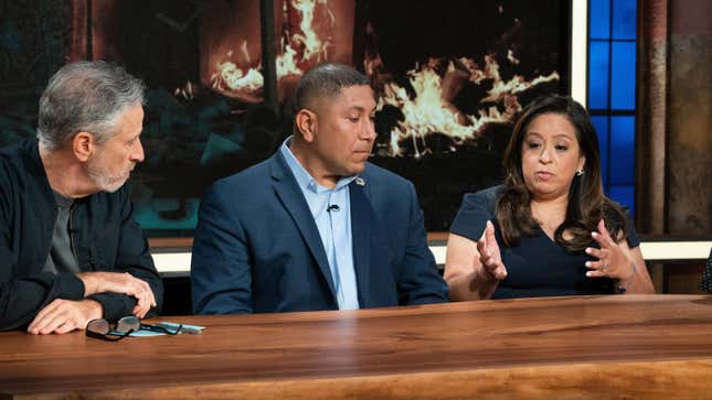 Jon Stewart with panelists Capt. Le Roy Torres (Ret.) and Rosie Torres on The Problem With John Stewart
