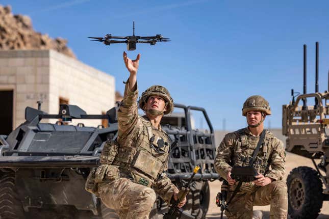 In this photo from the Defense Visual Information Distribution Service, British soldiers launch a drone during Project Convergence exercises at Fort Irwin, Calif., on Nov. 4, 2022. With tensions high over Taiwan, U.S. and Chinese military planners are readying themselves for a new kind of war where battleships, fighter jets and amphibious landings cede prevalence to squadrons of AI-enabled air and sea drones. (DVIDS via AP)