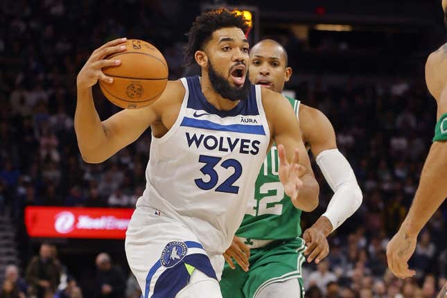 Nov 6, 2023; Minneapolis, Minnesota, USA; Minnesota Timberwolves forward Karl-Anthony Towns (32) drives to the basket past Boston Celtics center Al Horford (42) in the fourth quarter at Target Center.