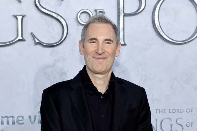 Andy Jassy smiling in front of a backdrop that says Lord of the Rings