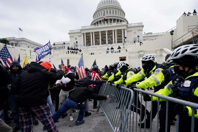 Insurrectionists loyal to President Donald Trump try to break through a police barrier, Wednesday, Jan. 6, 2021, at the Capitol in Washington. Facing prison time and dire personal consequences for storming the U.S. Capitol, some Jan. 6 defendants are trying to profit from their participation in the deadly riot, using it as a platform to drum up cash, promote business endeavors and boost social media profiles. 