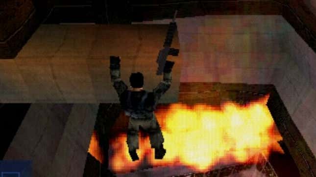 A man hangs from the ceiling above fire. 