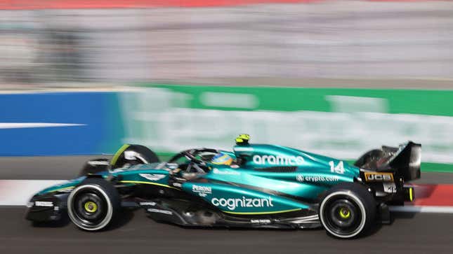 A photo of an Aston Martin Formula 1 car racing on track. 