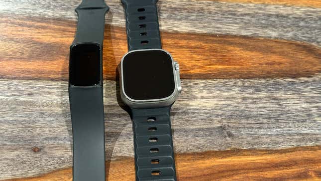 The Fitbit Charge 6 next to the Apple Watch Ultra 2.