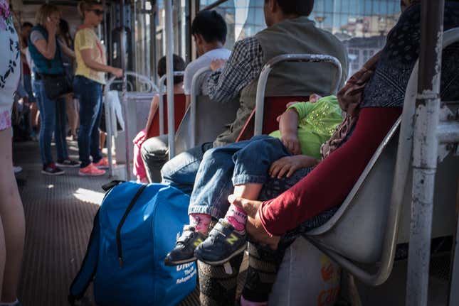 An Afghan family rides the tram between Krnjaca Refugee Camp to the center of Belgrade. Though young men are the most visible asylum-seekers in city parks, volunteers on-site say there is large number of families as well.