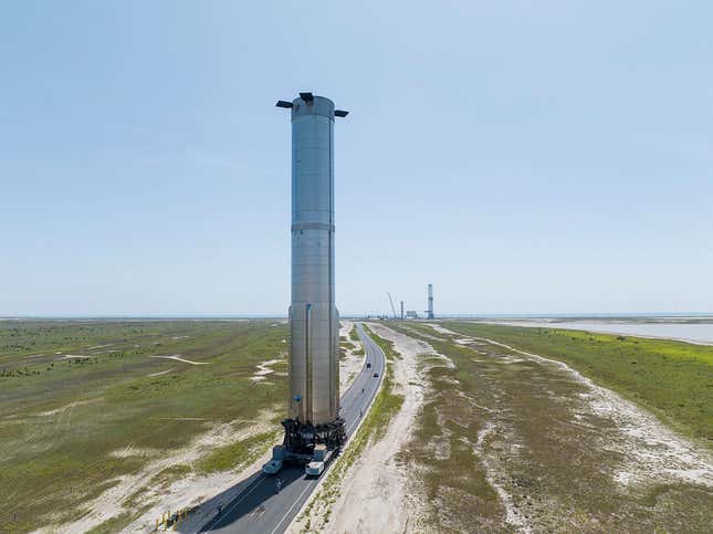 The SpaceX Super Heavy booster rocket heads for the launch pad.
