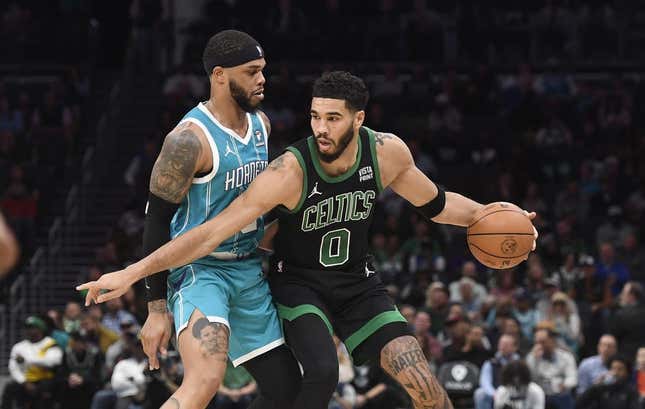 Nov 20, 2023; Charlotte, North Carolina, USA; Boston Celtics forward Jayson Tatum (0) looks to drive past Charlotte Hornets forward Miles Bridges (0) during the first half at the Spectrum Center.