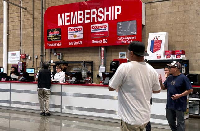 Customers walk by the membership counter at a Costco in Richmond, California. 