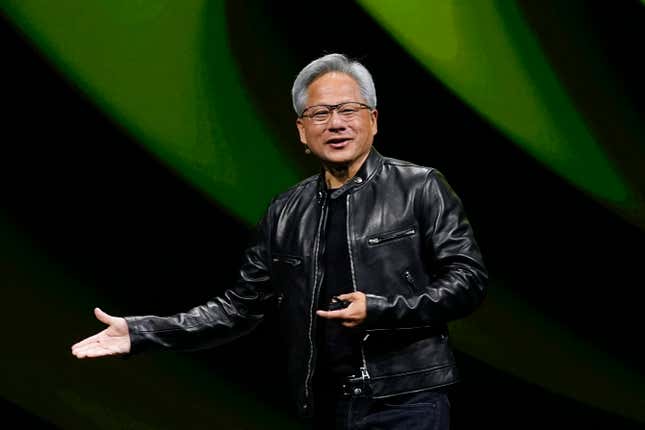 Jensen Huang wearing a black leather jacket gesturing to the right with his hands