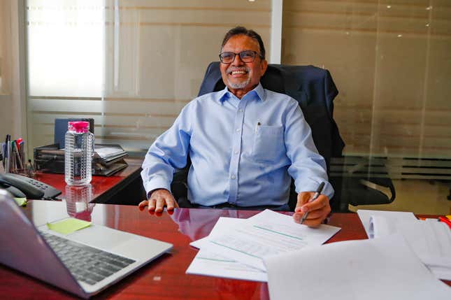 Rashmi Shah, CP Solar&#39;s Managing Director, smiles at his desk in Nairobi, Kenya, Friday, Sept. 1, 2023. Access to electricity remains a major challenge for over half a billion people in sub-Saharan Africa, and power outages are common. In South Africa and Kenya, solar is being used to power major businesses. (AP Photo/Brian Inganga)