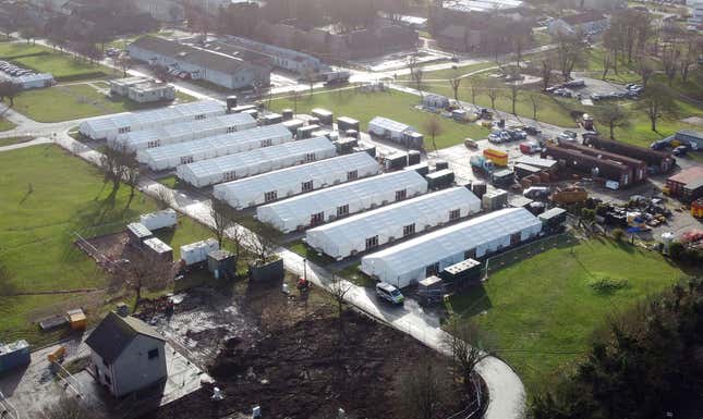 A view of the Manston immigration short-term holding facility located at the former Defence Fire Training and Development Centre in Thanet, Kent, England, Tuesday, Dec. 12, 2023. The first vote on on the proposed Rwanda Bill legislation, the stalled scheme to deport people crossing the English Channel to Kigali, will be held in the House of Commons Tuesday. (Gareth Fuller/PA via AP)