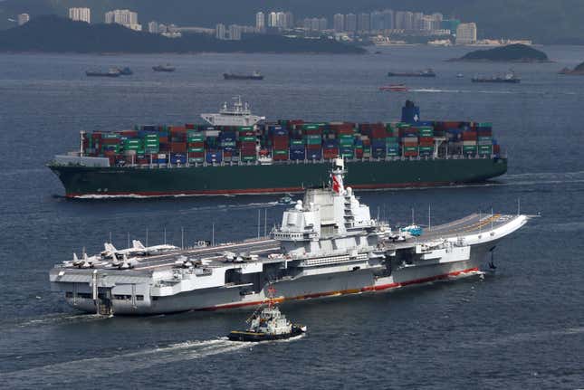 China's aircraft carrier Liaoning sails past a container ship as it enters Hong Kong, China July 7, 2017.
