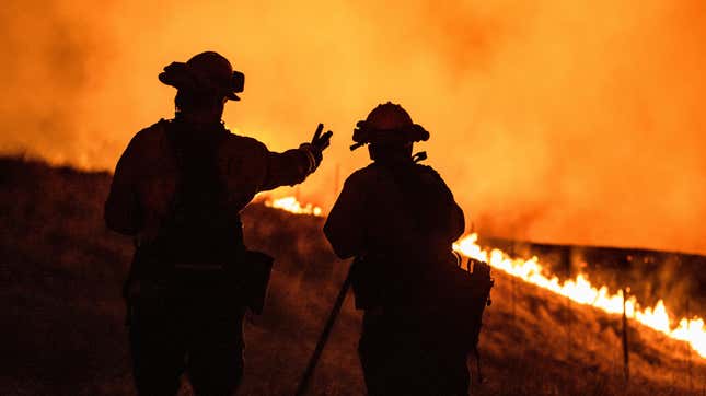 Fire fighters keep watching an approaching fire line on the outskirts of Santa Rosa, on September 27, 2020.