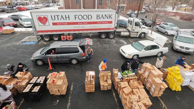 FILE - Utah Food Bank volunteers load groceries for the needy at a mobile food pantry distribution site Wednesday, Dec. 21, 2022, in Salt Lake City. Supporting nonprofits on GivingTuesday this year could have a bigger impact than usual as nonprofits and industry groups say donations so far are down compared with previous years. Many organizations will be looking to make up the difference on GivingTuesday, which is the Tuesday after Thanksgiving, Nov. 28, 2023. (AP Photo/Rick Bowmer)