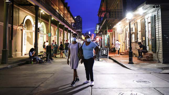  People wearing face masks walk on Bourbon Street in the French Quarter on August 12, 2021 in New Orleans, Louisiana. 
