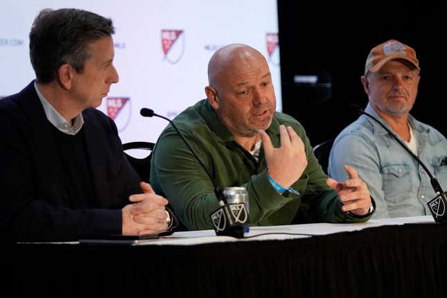 Paul Martin, center, co-founder of Box to Box Films, speaks during a news conference as Seth Bacon, left, executive vice president, Media for Major League Soccer, and Steve Rankin, right, producer and show runner of Box To Box Films, look on at the MLS 2024 Media Day, Thursday, Jan. 11, 2024, in Miami Beach, Fla. Apple TV and Major League Soccer are expanding their collaboration, announcing Thursday that the looming MLS season will be chronicled in a new all-access docuseries similar to the ones that have given fans a deep, different look at golf, auto racing and tennis in recent months. (AP Photo/Wilfredo Lee)