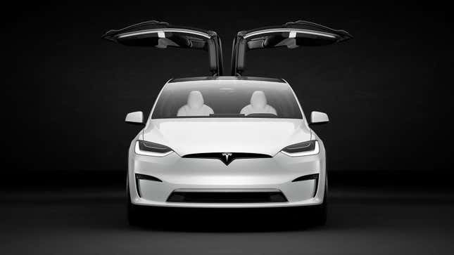 A photo of a Tesla Model X SUV with its gullwing doors open. 