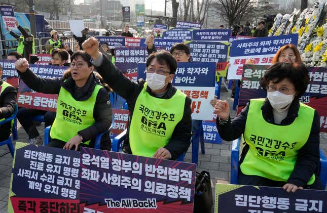 Members of the Gyeonggi Province Medical Association stage a rally against the government&#39;s medical policy near the presidential office in Seoul, South Korea, Wednesday, March 13, 2024. South Korea&#39;s government criticized senior doctors at a major hospital Tuesday for threatening to resign in support of the weekslong walkouts by thousands of medical interns and residents that have disrupted hospital operations. The banners read &quot;Stop President Yoon Suk Yeol government&#39;s medical policy.&quot; (AP Photo/Ahn Young-joon)