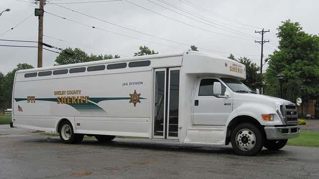 A photo of a white Ford prison bus, 