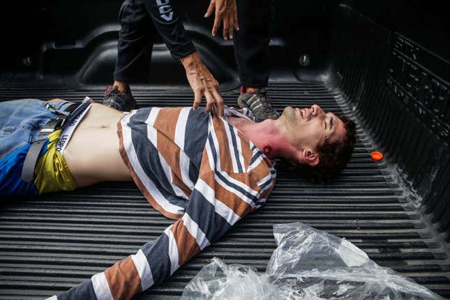 A wounded protestor receives medical assitance from emergency staff