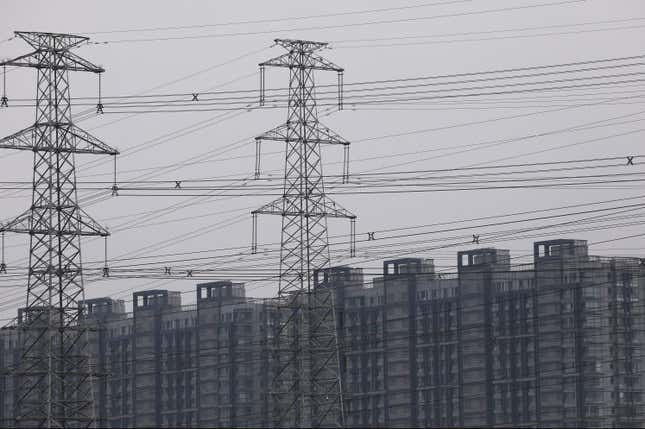 Electricity transmission towers are pictured near residential buildings in Beijing.
