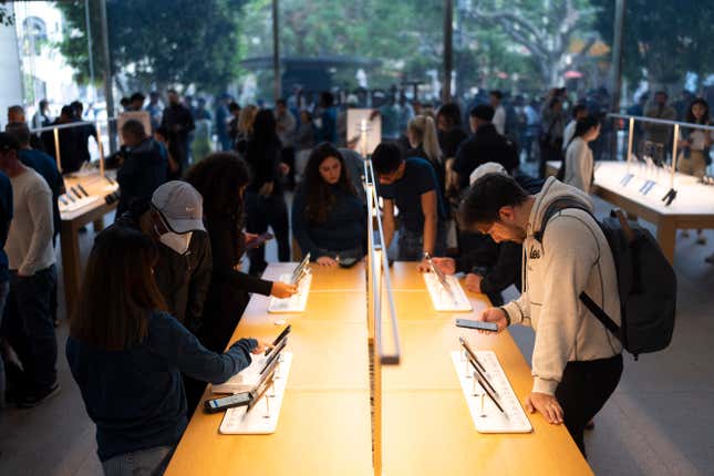 FILE -= People look at the Apple&#39;s new iPhone 15 models on the first day of sales at an Apple Store at The Grove in Los Angeles, Friday, Sept. 22, 2023. For the first time in a year, the big companies in the S&amp;P 500 may be seeing their profits grow again. (AP Photo/Jae C. Hong, File)