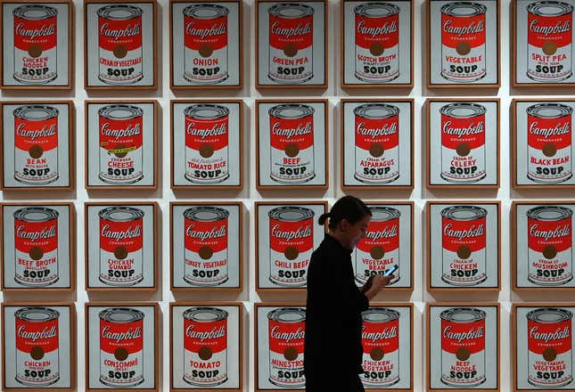 A woman walks past Andy Warhol “Campbell’s Soup Cans” at the Museum of Modern Art (MOMA). 