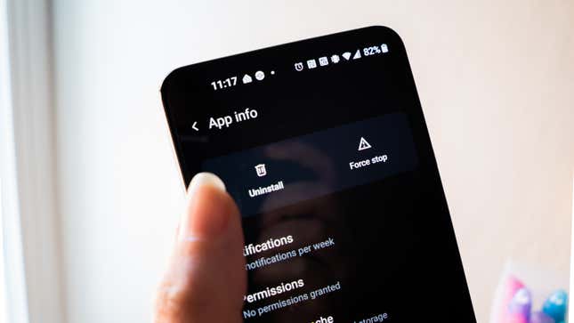 A photo of a finger hovering over the "uninstall" button in the android settings