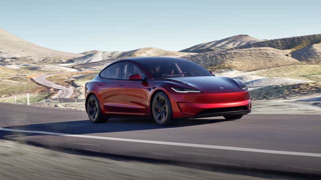 A new red Tesla Model 3 Performance from a front three-quarters view while driving down a road