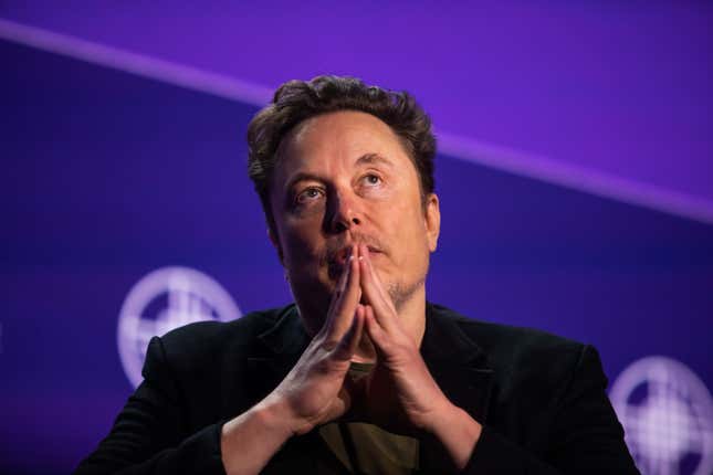 elon musk with his hands put together in front of his face looking upwards