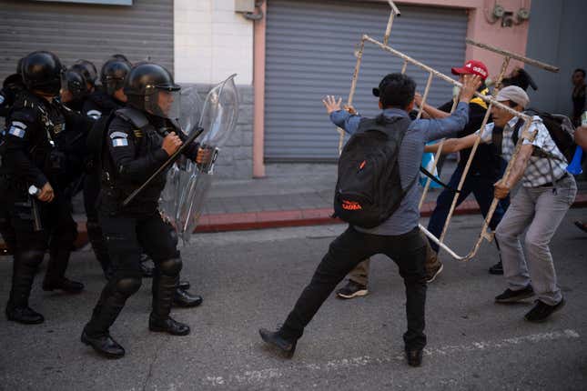 Supporters of Guatemalan President-elect Bernardo Arévalo, right, face off with police outside Congress, to protest a delay in the start of the legislative session to swear-in new lawmakers on Arévalo&#39;s inauguration Day in Guatemala City, Sunday, Jan. 14, 2024. (AP Photo/Santiago Billy)