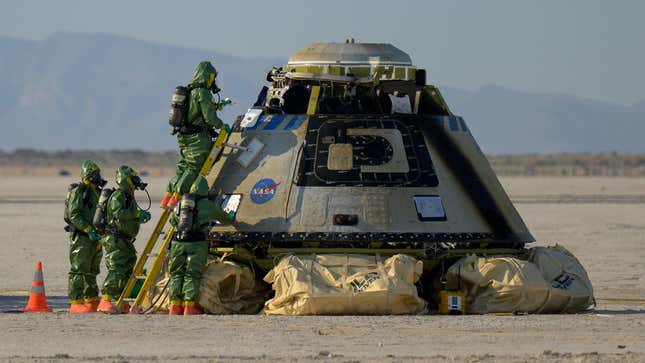 Hazmat teams work around Boeing’s Starliner spacecraft after it landed at White Sands Missile Range’s Space Harbor, May 25, 2022, in New Mexico for the company’s Orbital Flight Test-2.