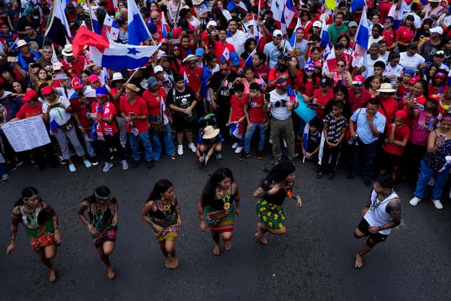 Embera Indigenous women dance as Panamanians celebrate after the Supreme Court declared a 20-year contract with a Canadian copper mine unconstitutional, in Panama City, Tuesday, Nov. 28, 2023. Panama&#39;s Supreme Court ruled unanimously that the concession that has been the focus of widespread environmental protests was unconstitutional, after which the president of the Central American country said the process to close the mine would begin. (AP Photo/Arnulfo Franco)